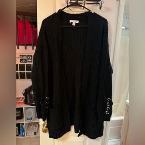 Black cardigan with cross cross design on sleeves